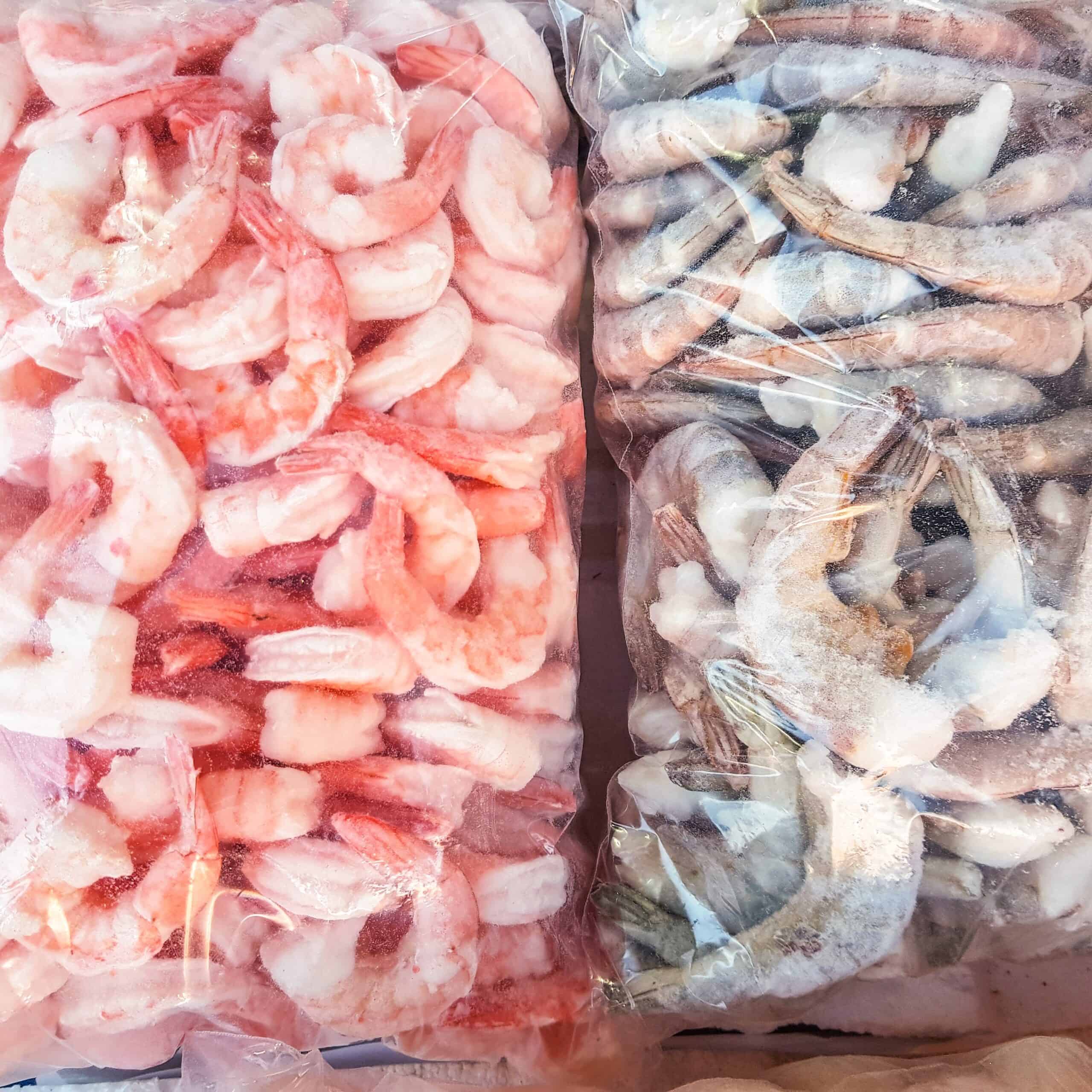 Two,Large,Plastic,Bags,Of,Frozen,Raw,And,Cooked,Shrimp,