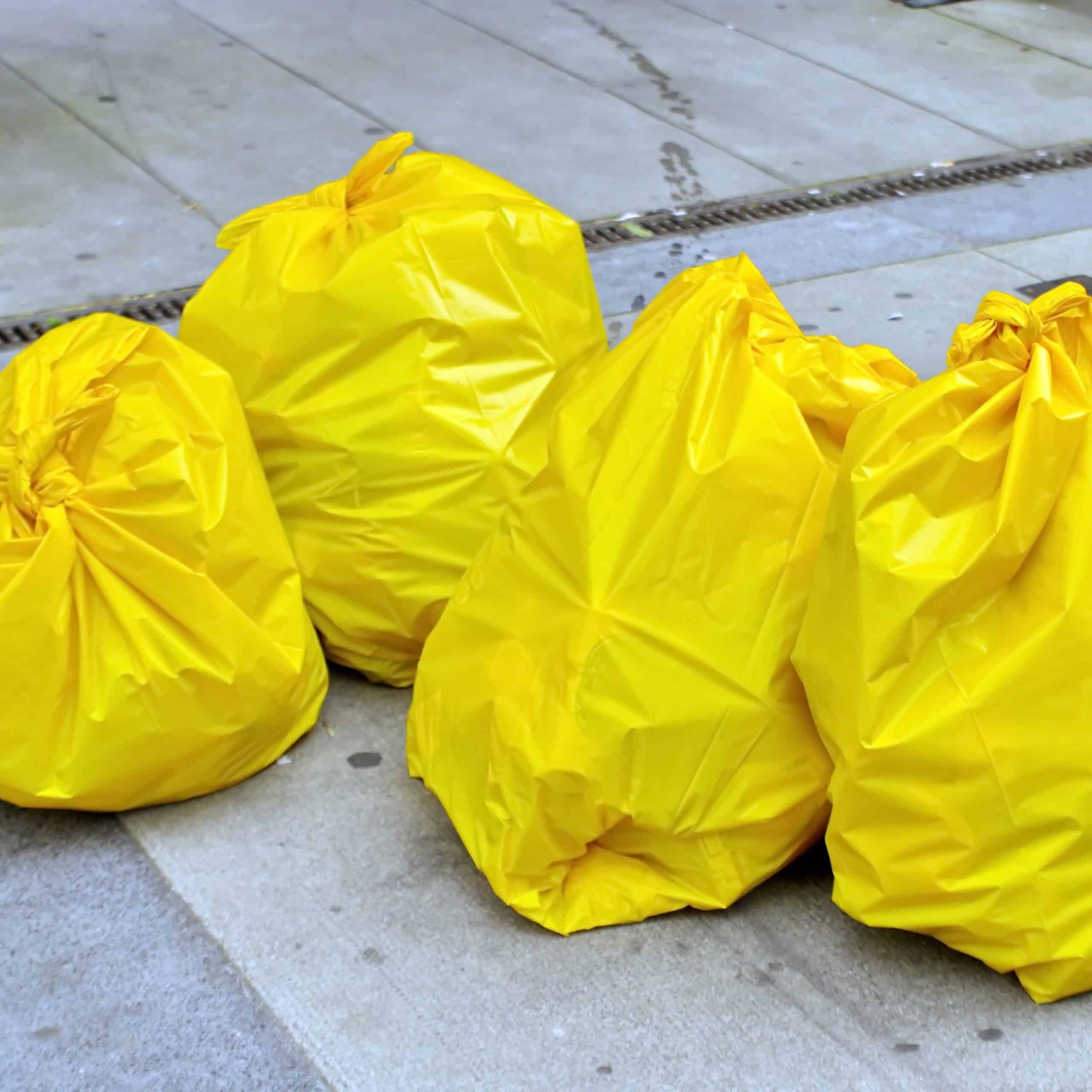 Four,Yellow,Garbage,Bags,On,The,Street