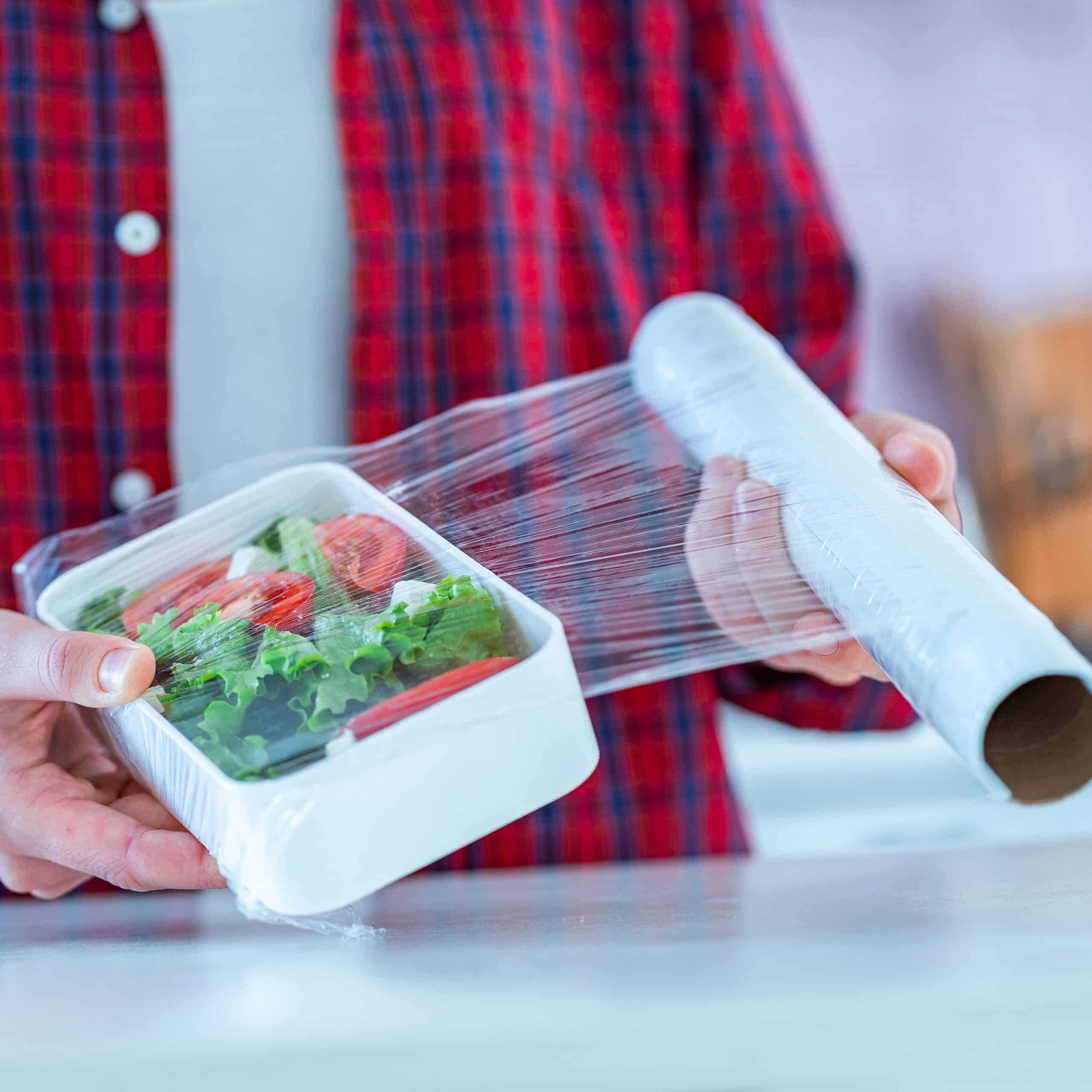 Using food polyethylene plastic film for food storage in fridge at home