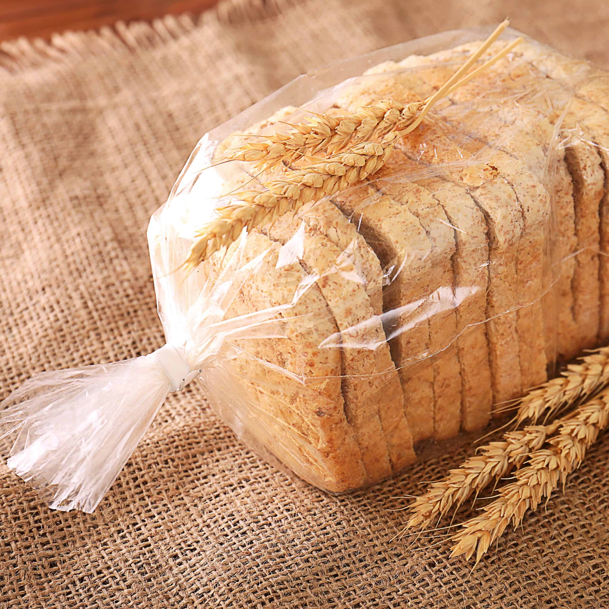 Sliced,Bread,In,Plastic,Bag,On,Sackcloth,With,Wheat,Spikes