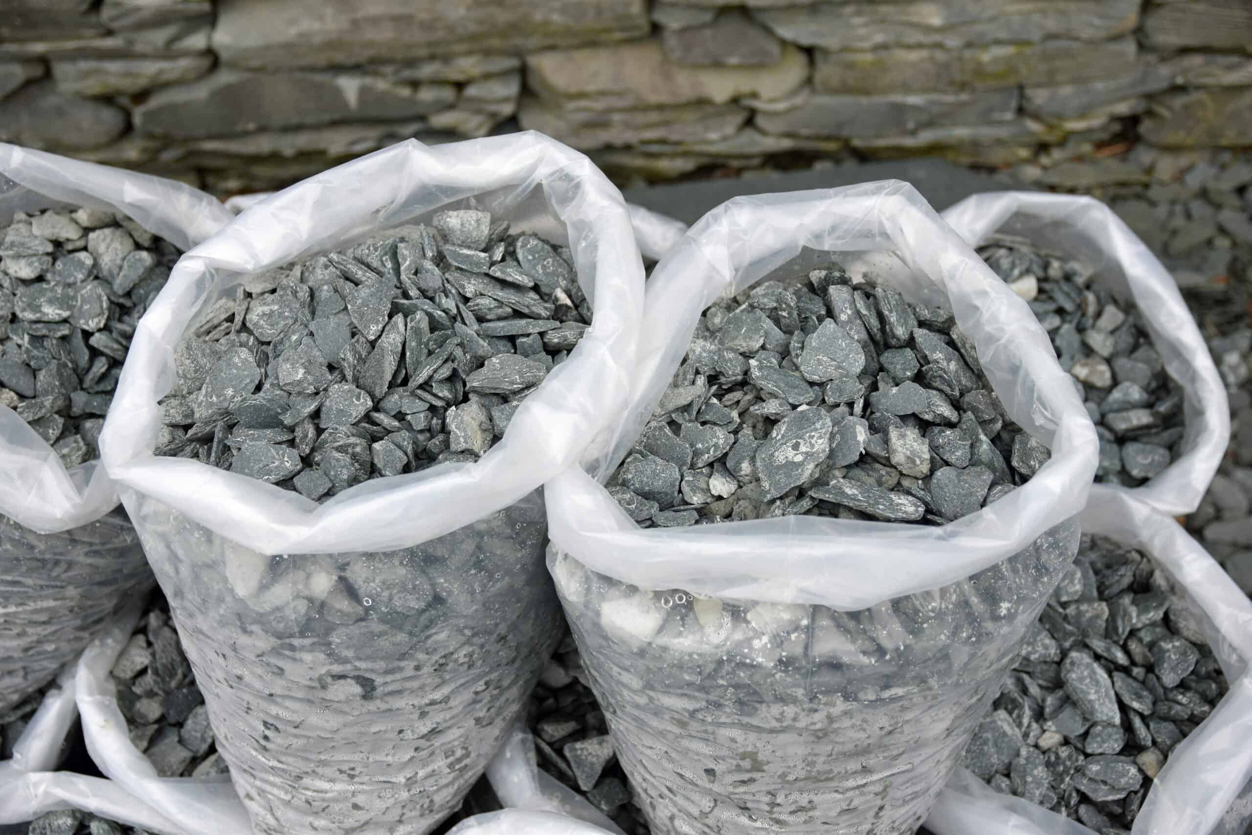 Close,Up,Of,Grey,Slate,Chippings,For,Sale,In,Plastic