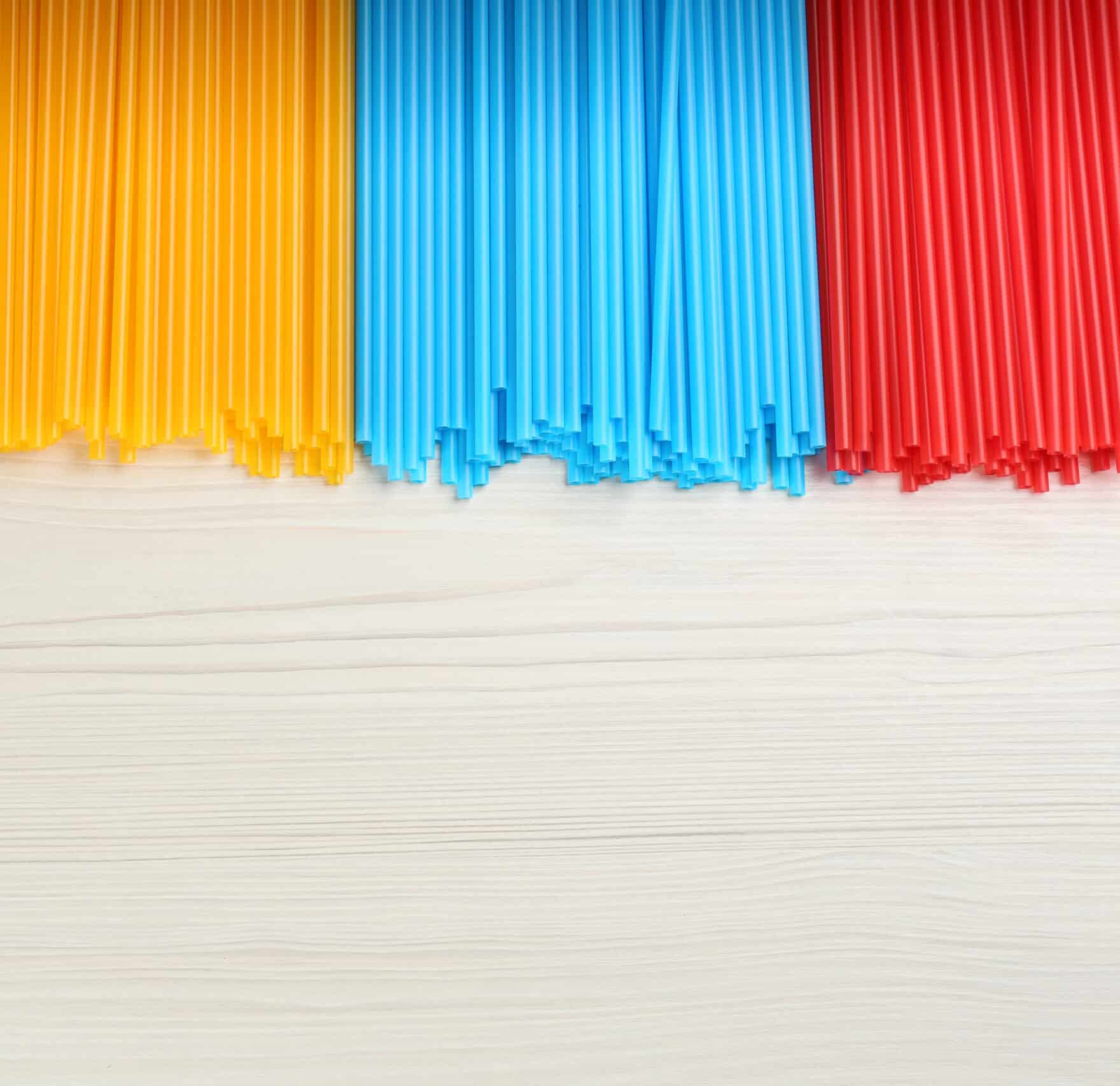 Colorful,Plastic,Drinking,Straws,On,White,Wooden,Table,,Flat,Lay.